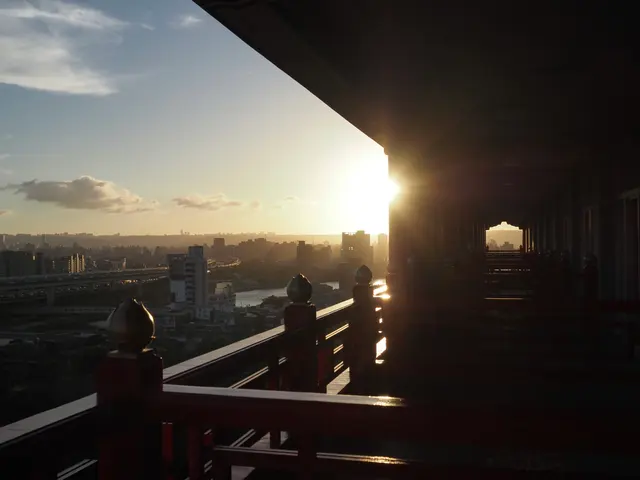 Photographed at Taipei's Grand Hotel, where the setting sun enters from the end of the corridor and runs along the railings and eaves above a silhouetted city.