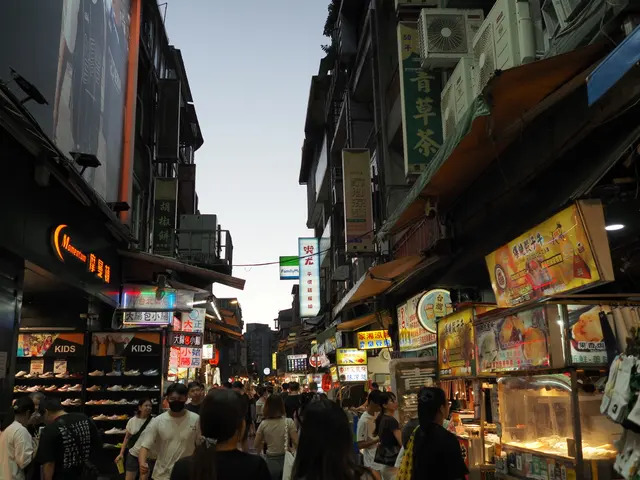 Photographed at Shilin Night Market in Taipei just after dusk, as dense food signs and shop lights come on and crowds move deeper into the narrow street.
